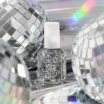 silver glitter essie brand nail polish bottle with disco balls