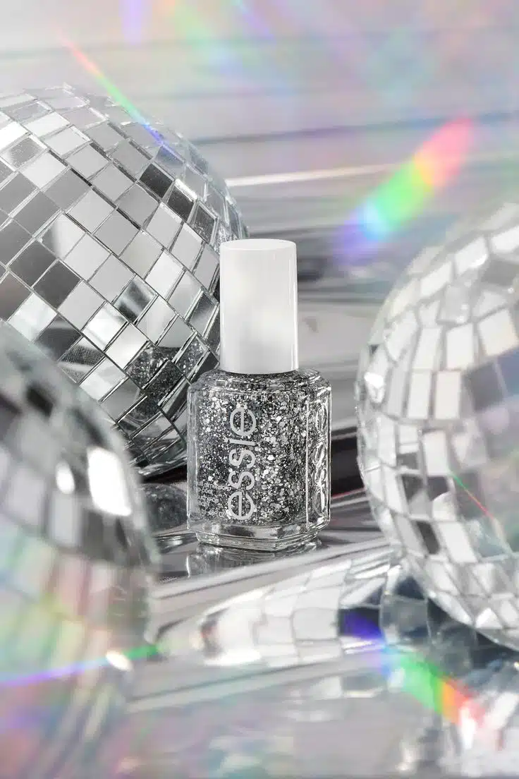 silver glitter essie brand nail polish bottle with disco balls