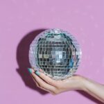 hand holding a disco ball by stocksy contributor cactus creative studio (1)